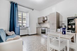 a living room with a table and a kitchen at Trastevere’s Flower in Trastevere