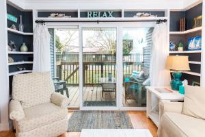 a living room with a sliding glass door to a deck at Ocean Glass Condominiums in Rehoboth Beach