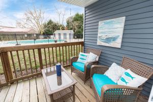 a patio with two chairs and a table on a deck at Ocean Glass Condominiums in Rehoboth Beach