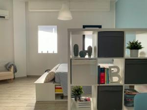 a bedroom with a bed and a book shelf at Dimora Anna in Termoli +3 photos
