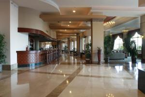 a lobby of a hotel with a bar at Fame Residence Lara & Spa in Lara