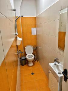 a small bathroom with a toilet and a sink at Студио Top City Center in Plovdiv