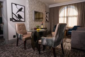 a living room with a table and chairs at Golden Horse Hotel 