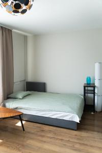a bedroom with a bed and a table at Warm & Cozy Apartment with balcony in Valmiera in Valmiera