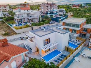 an aerial view of a house with a swimming pool at Villa RougeMarin - Rouge with private pool in Medulin