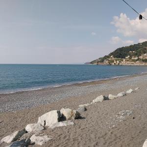a group of rocks on a beach with a kite at ANFORA HOUSE in Genoa