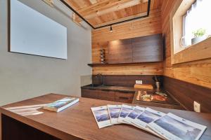 a kitchen with wooden walls and a wooden table at Xeis Natur Apartments in Johnsbach