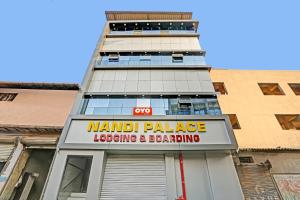 a building with a sign for a manual palaceleasing andboarding at Flagship Nandi Palace Lodging And Boarding in Mumbai