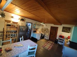 a kitchen with a table and a counter in a room at Chalupa pri Čerešni “Moja srdcovka” in Staré Hory