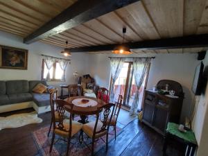 a living room with a table and a couch at Chalupa pri Čerešni “Moja srdcovka” in Staré Hory