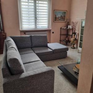 a living room with a couch and a table at Villa Radi Cornaredo Rho Fiera in Cornaredo