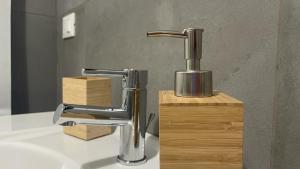 a bathroom sink with a chrome bathroom faucet at Doctor House standard, suites & luxury rooms in Enna +69 photos