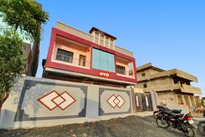 a building with a motorcycle parked in front of it at OYO Raj Hotel in Nagpur