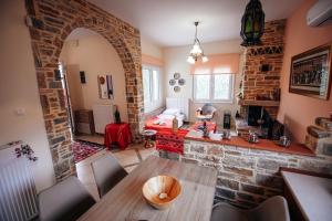 a living room with a table and a brick wall at DAFNI'S HOME in Volos