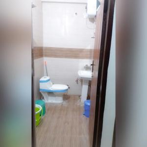 a small bathroom with a toilet and a sink at Silver Dew Resorts and Restaurant in Dhanaulti