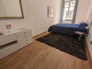 a bedroom with a bed and a dresser and a mirror at Papavero 69 in Bergamo