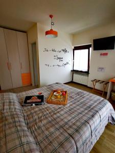 a bedroom with a bed with a tray of fruit on it at B & B La Mela in Darfo