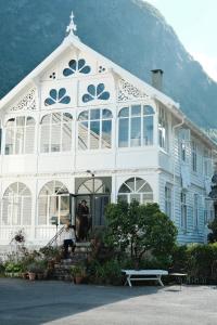 a large white building with people standing outside of it at Hardanger Fjord Lodge in Bondhus