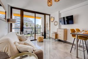 a living room with a couch and a table at Sea Cocoon in Playa de las Americas