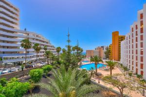a view of a city with a pool and buildings at Sea Cocoon in Playa de las Americas