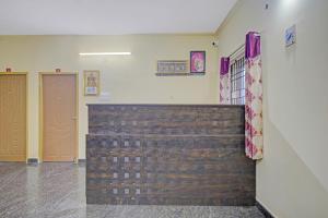 a room with a brick wall and two doors at Vsv Guest House in Chennai