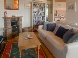 a living room with a couch and a fireplace at Apartment 235 Roundstone in Roundstone