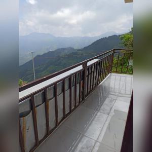 a balcony with a view of the mountains at Silver Dew Resorts and Restaurant in Dhanaulti
