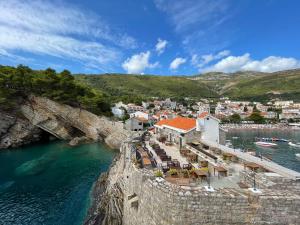 a town on a cliff next to the water at 4M Apartments in Petrovac na Moru