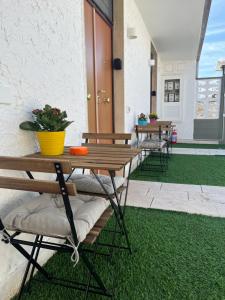 a patio with benches and a table with a plant at Truly Apulia in Bari