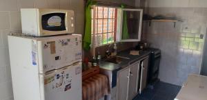 a kitchen with a microwave on top of a refrigerator at La Chiqui - Quinta - Alquiler Temporario in Formosa