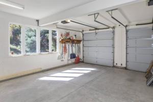 an empty garage with white walls and windows at Sneffels in Telluride