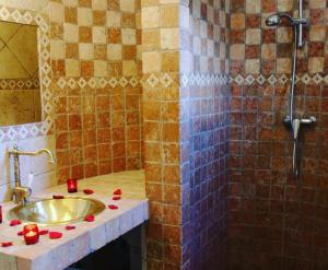 a bathroom with a sink and a shower with candles at A Furtezza in Soveria