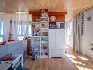 a living room with a large white book shelf at Casa Poniente - Casa Rural Los Cuatro Vientos in Moratalla