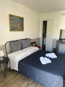 a bedroom with a bed with two towels on it at Truly Apulia in Bari