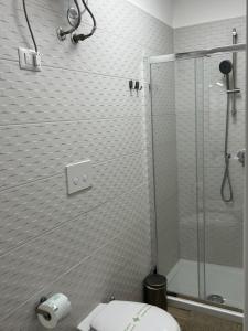 a bathroom with a toilet and a glass shower at Truly Apulia in Bari