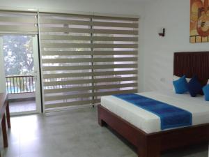 A bed or beds in a room at Anantamaa Hotel