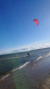 una persona che pratica kiteboarding sull'acqua della spiaggia di DIONIZY a Kosakowo