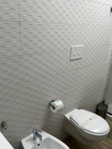 a bathroom with a toilet and a sink at Truly Apulia in Bari