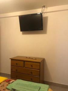 a bedroom with a dresser and a flat screen tv on the wall at Vientos del Sur in Río Gallegos