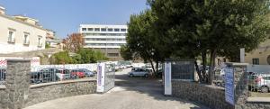 a gate with cars parked in a parking lot at B&B Nonno Walter in Torre del Greco