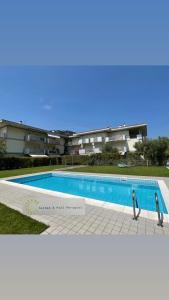 a large swimming pool in front of a building at Garden & Pool Perugini in Nago-Torbole