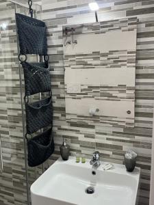 a bathroom with a sink and a mirror at Truly Apulia in Bari