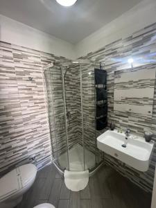 a bathroom with a shower and a sink and a toilet at Truly Apulia in Bari