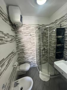 a bathroom with a shower and a toilet and a sink at Truly Apulia in Bari