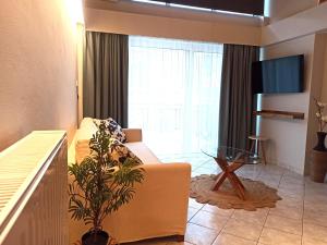 a living room with a couch and a glass table at Filikon maisonettes in Kalamata