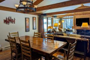 a dining room with a wooden table and chairs at Golf Creek12 in Teton Village
