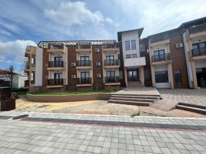 a large brick building with a courtyard in front of it at Apartman S2 in Ostrovo