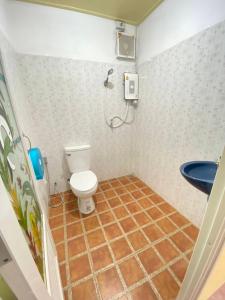 a bathroom with a toilet and a sink at At Sichon Resort in Sichon