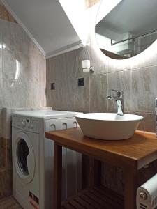 a bathroom with a sink and a washing machine at Filikon maisonettes in Kalamata +73 photos