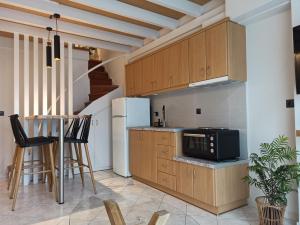 a kitchen with wooden cabinets and a stove at Filikon maisonettes in Kalamata